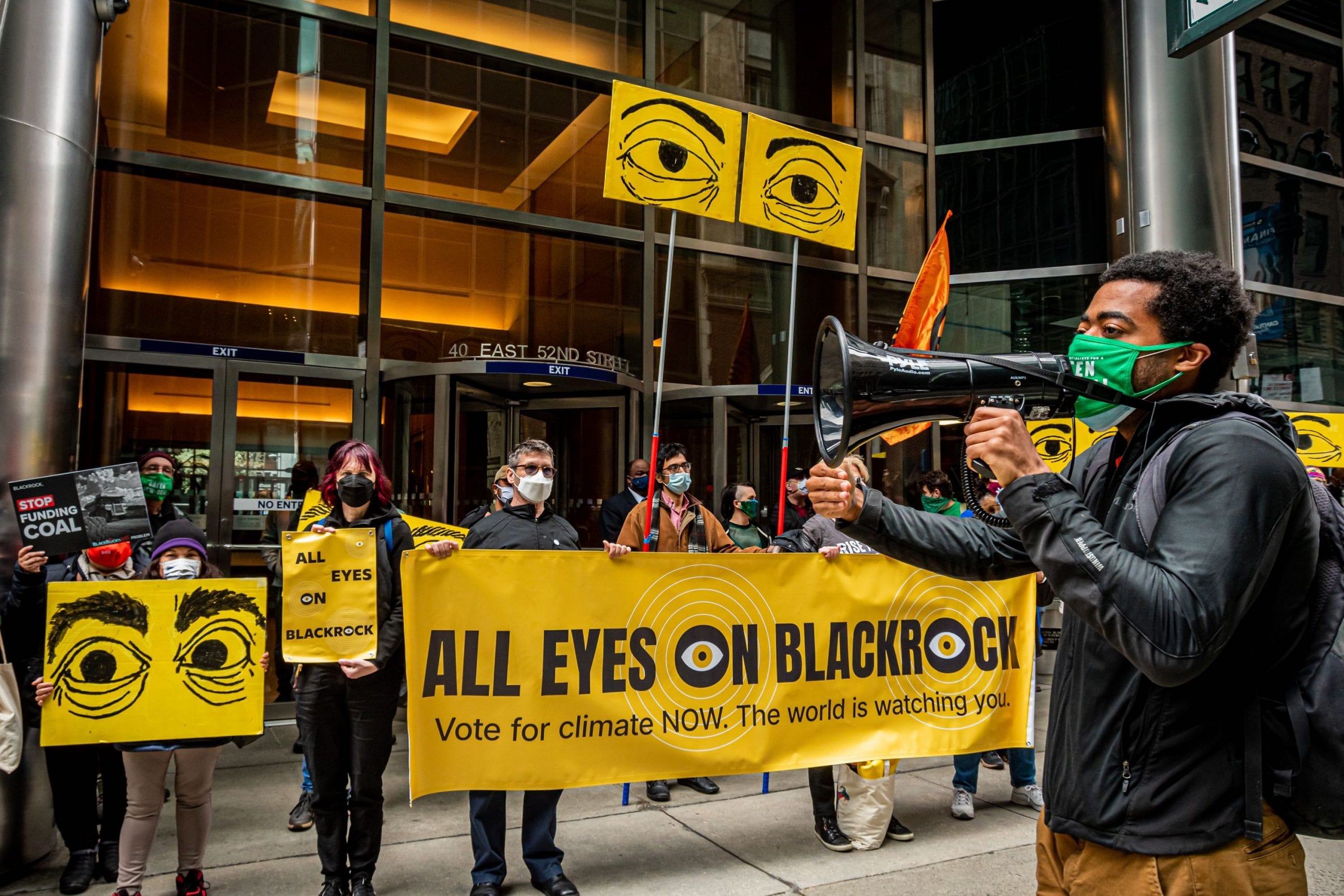 Activists hold All Eyes On BlackRock banner outside BlackRock headquarters
