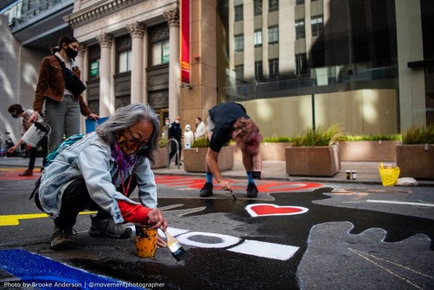 Activists paint mural at Wells Fargo World HQ on Montgomery Street in San Francisco